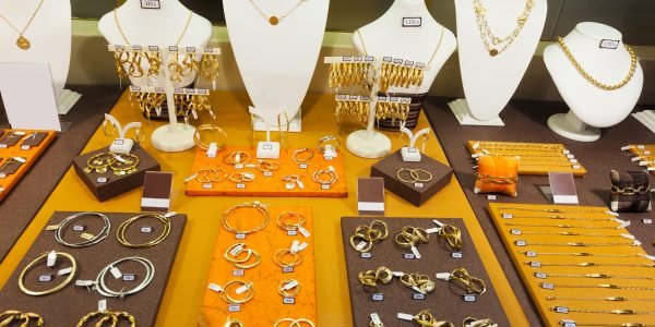 counter with golden jewelry in store window